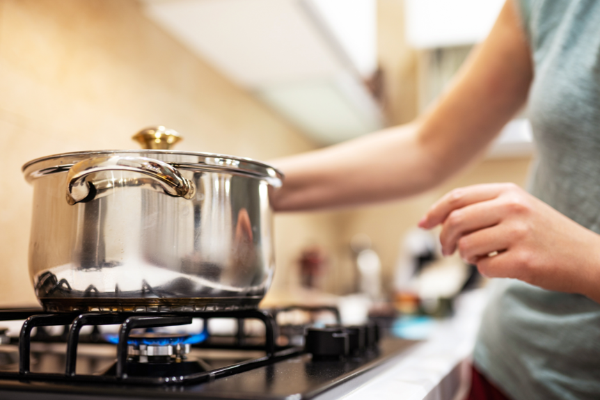 Person cooking on a gas stove