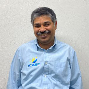 Indian man smiling wearing a blue ICAST shirt